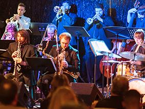 MSU Denver Big Band horn section performing in colorful lights